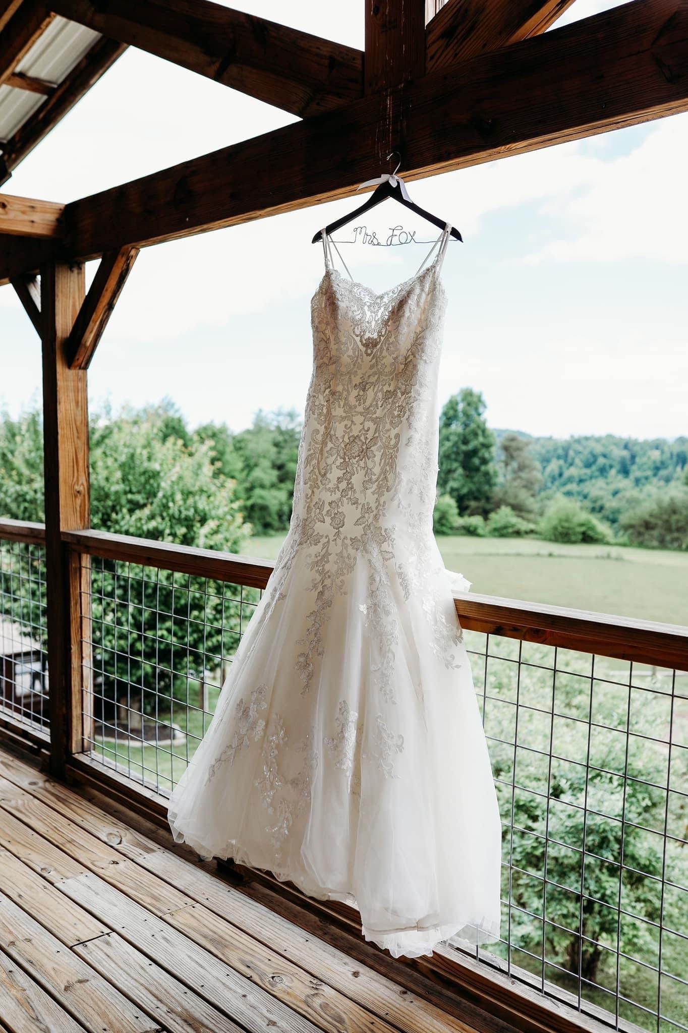 A wedding dress hanging in the bridal suite