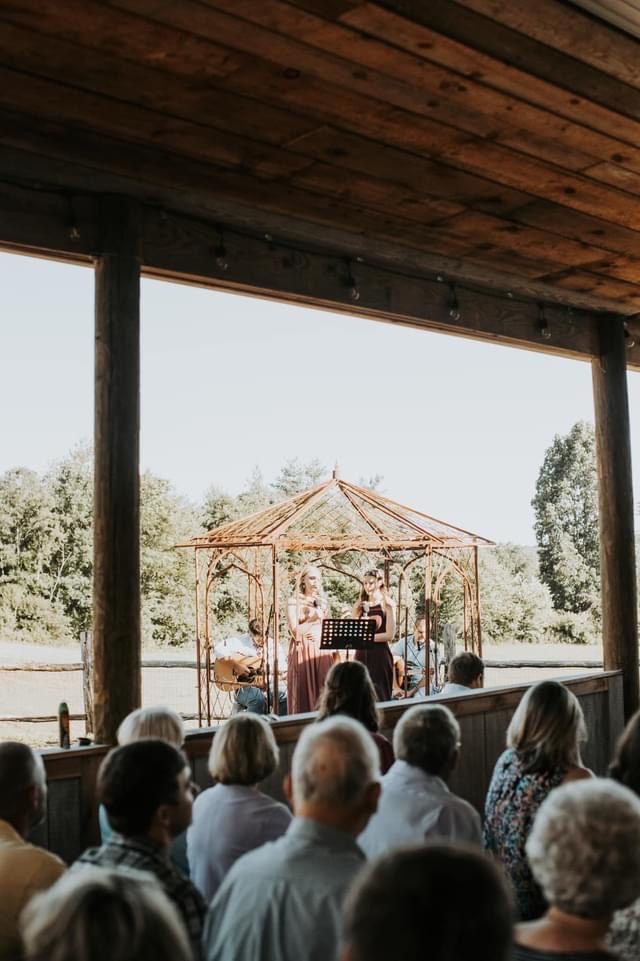 An open-air pavilion ceremony with mountain views